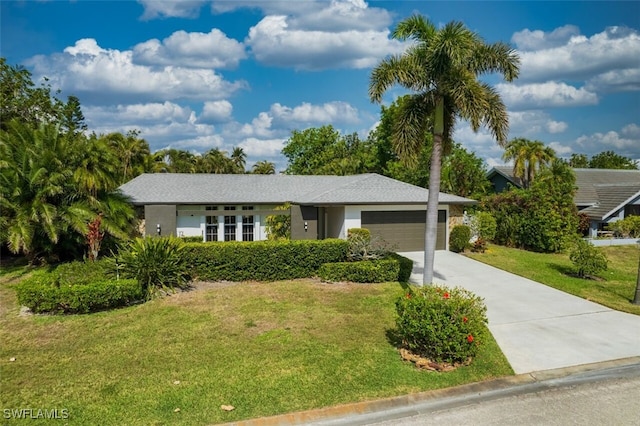 ranch-style home with a garage and a front yard