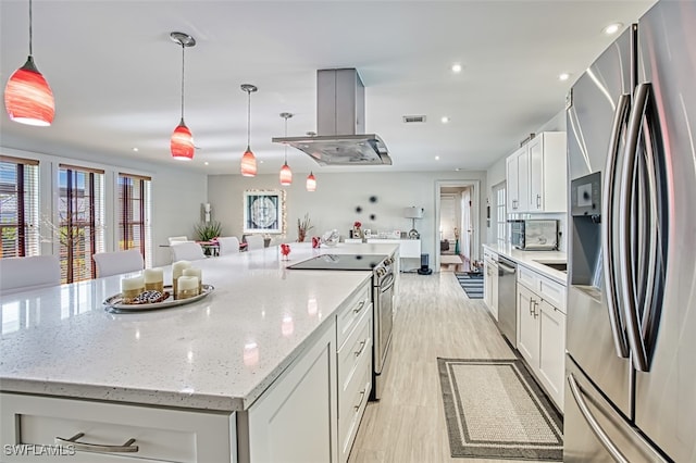 kitchen featuring pendant lighting, island exhaust hood, stainless steel appliances, a large island, and white cabinets