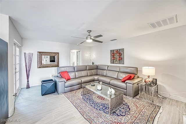 living room with light hardwood / wood-style flooring and ceiling fan