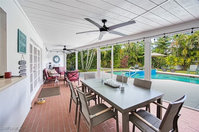 sunroom featuring ceiling fan