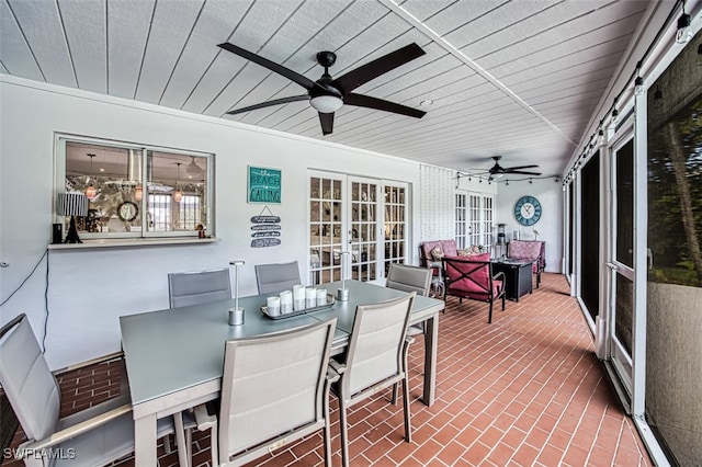 sunroom / solarium featuring french doors and ceiling fan