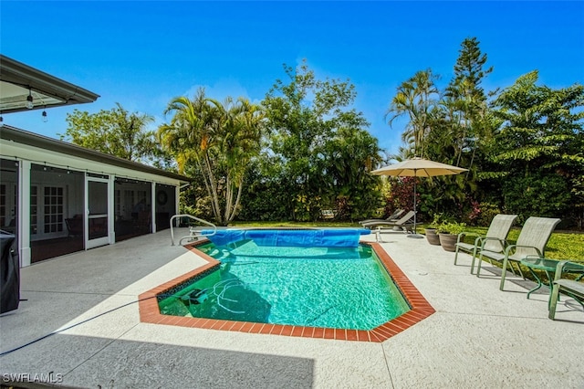 view of swimming pool featuring a patio area