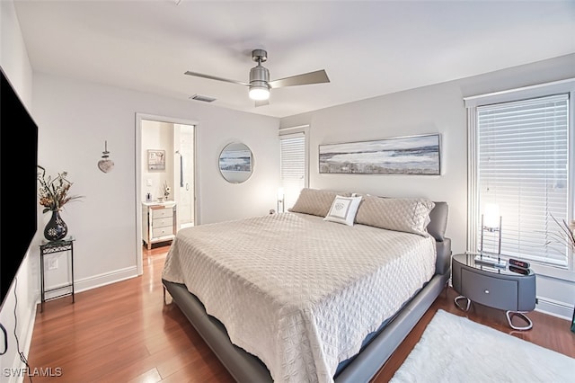 bedroom featuring wood-type flooring, ensuite bathroom, and ceiling fan