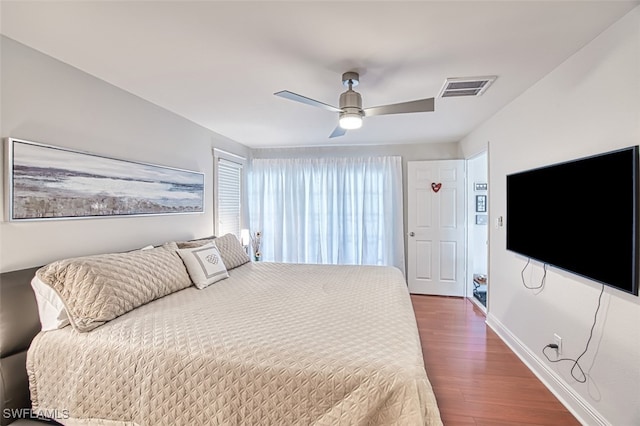 bedroom with dark wood-type flooring and ceiling fan