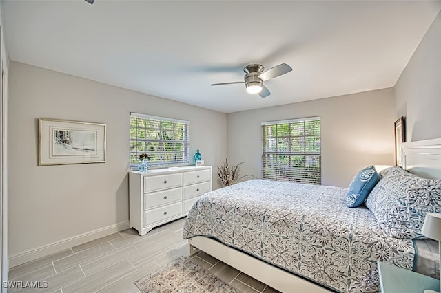 bedroom with ceiling fan and multiple windows