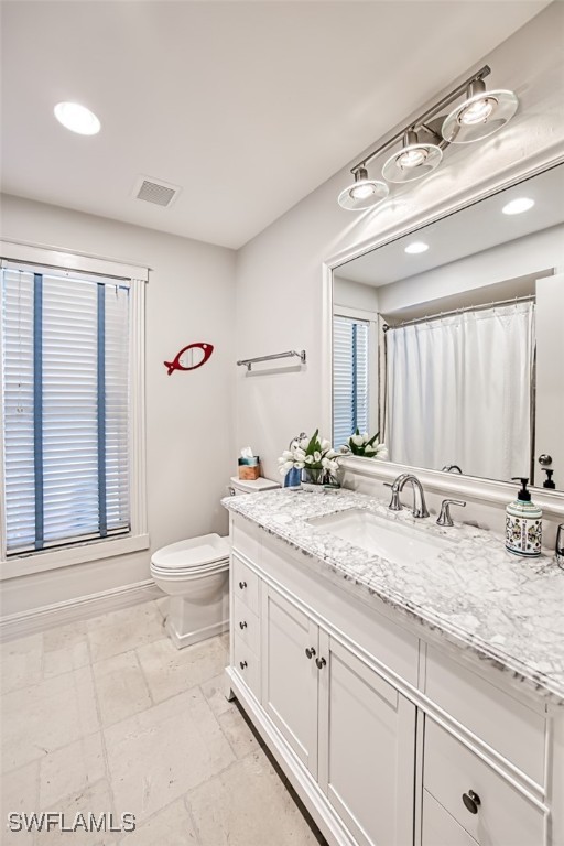 bathroom with vanity, a shower with curtain, and toilet