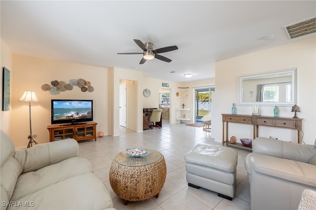 tiled living room featuring ceiling fan