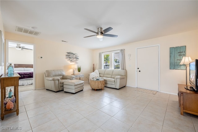 living room featuring light tile patterned floors and ceiling fan