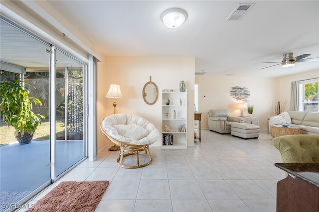 tiled living room featuring ceiling fan