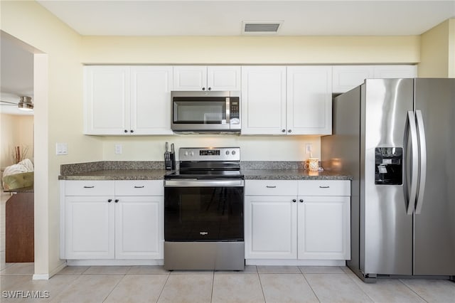 kitchen featuring white cabinetry, light tile patterned flooring, and appliances with stainless steel finishes