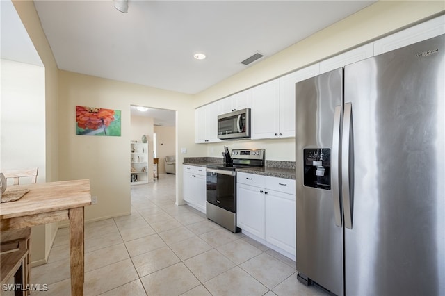 kitchen featuring light tile patterned floors, white cabinets, and appliances with stainless steel finishes