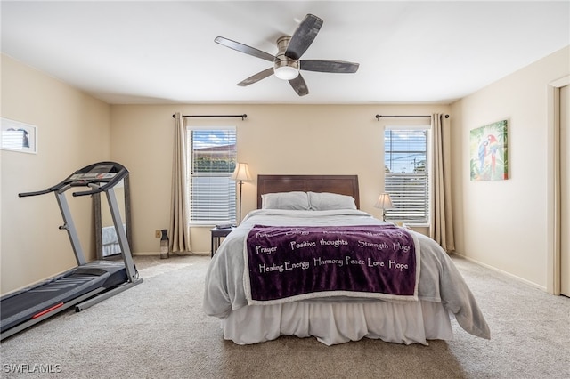 carpeted bedroom with ceiling fan and multiple windows