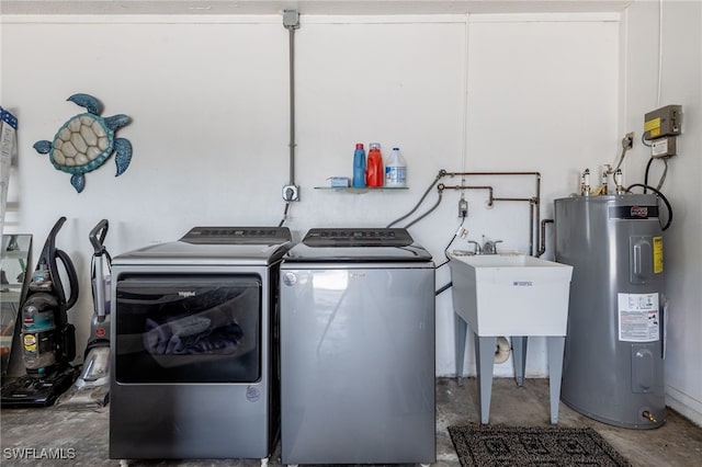 washroom featuring water heater, sink, and washer and clothes dryer