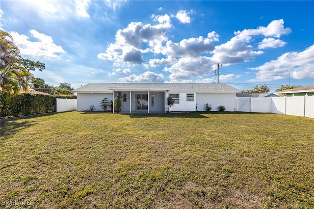 back of property featuring a yard