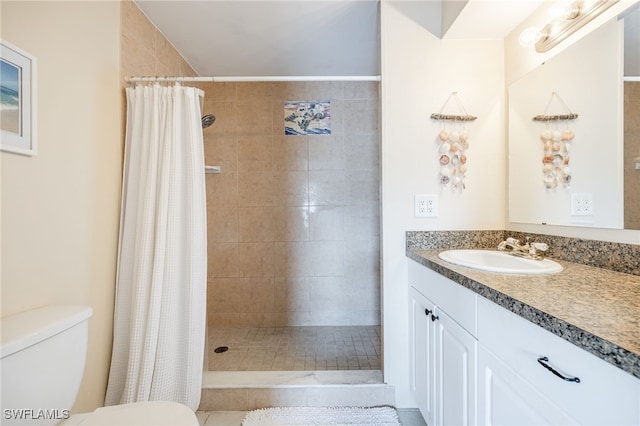 bathroom featuring walk in shower, vanity, and toilet