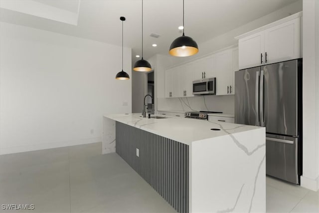 kitchen with white cabinetry, pendant lighting, stainless steel appliances, and a large island with sink