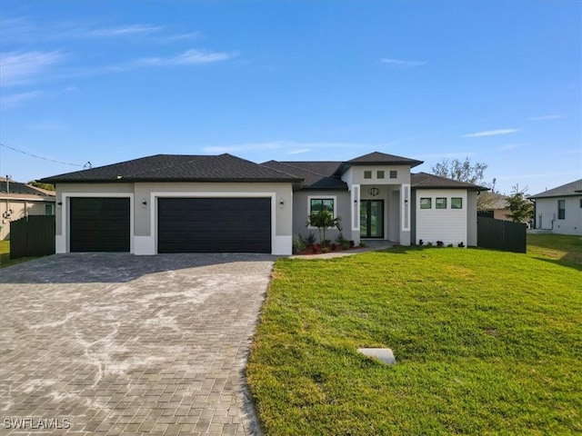 prairie-style home with a garage and a front yard