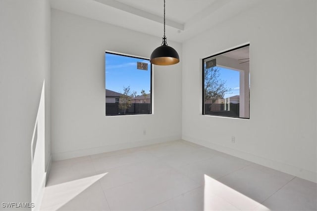 tiled spare room with a tray ceiling