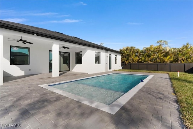 view of swimming pool featuring ceiling fan and a patio area