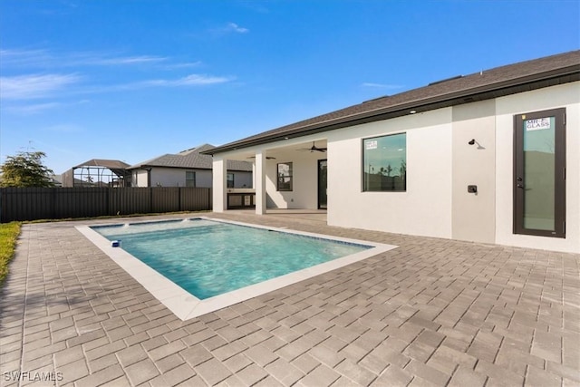 view of swimming pool with a patio area and ceiling fan