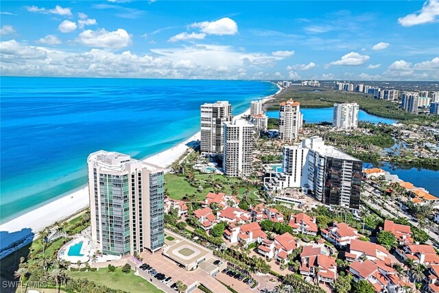 birds eye view of property with a view of the beach and a water view