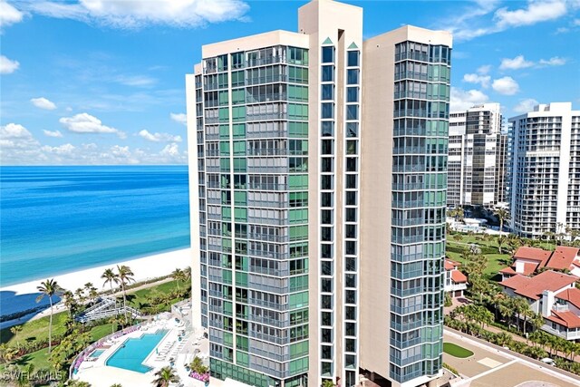 view of building exterior with a view of the beach and a water view