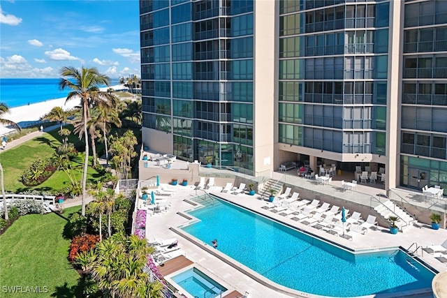 view of pool featuring a water view and a patio area