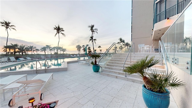 patio terrace at dusk with a community pool