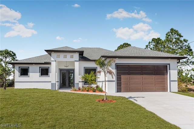 prairie-style home with a garage and a front lawn