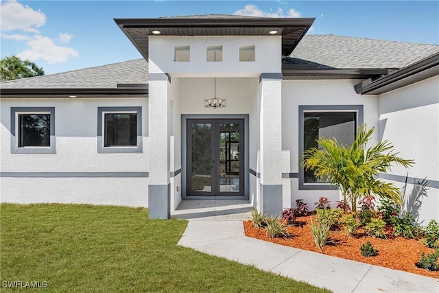 doorway to property with a yard and french doors