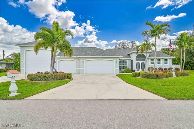 single story home featuring a garage and a front lawn