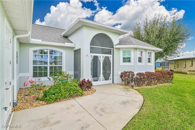 property entrance featuring french doors and a lawn