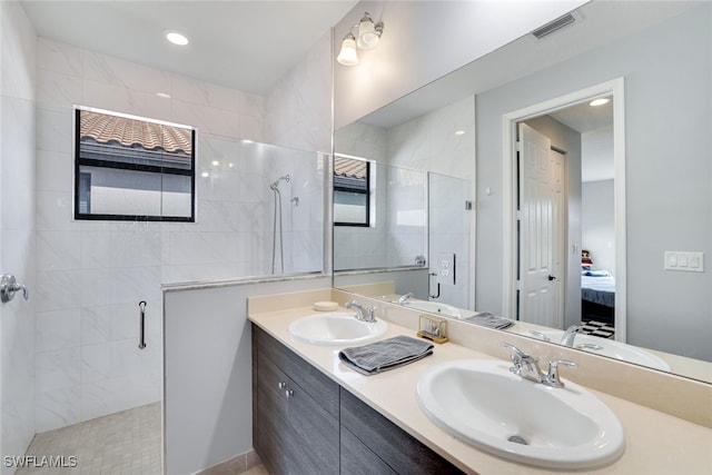 ensuite bathroom with a sink, visible vents, a shower stall, and ensuite bath