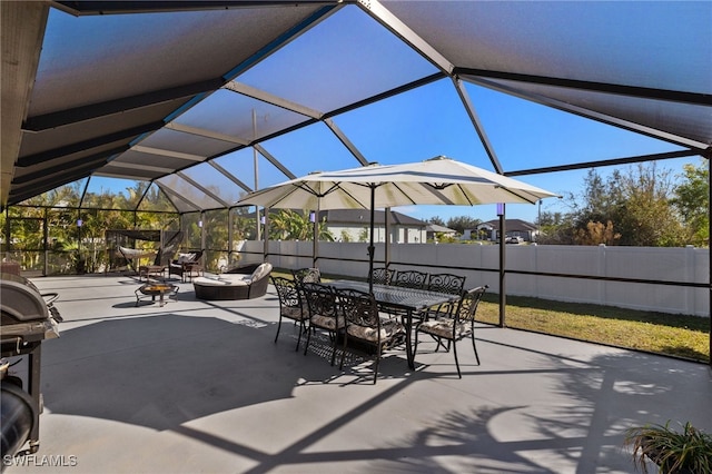 view of patio featuring glass enclosure