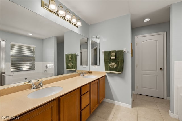 bathroom with vanity, a bath, and tile patterned floors