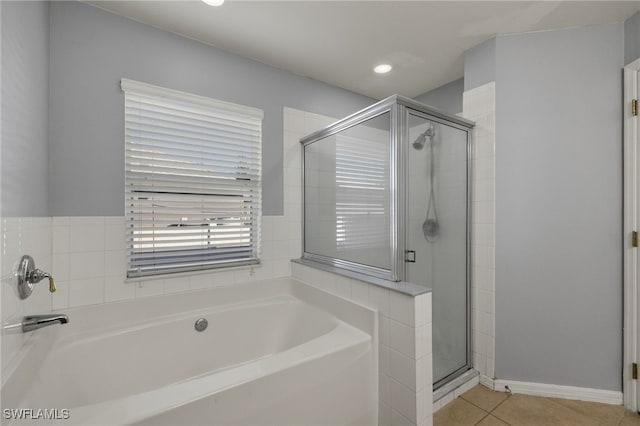 bathroom with tile patterned floors and shower with separate bathtub