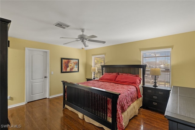 bedroom with dark hardwood / wood-style floors and ceiling fan