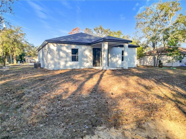 back of property with central AC