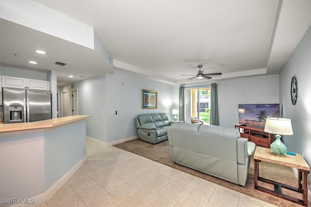 living room with light tile patterned floors and ceiling fan