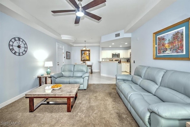 carpeted living room with ceiling fan