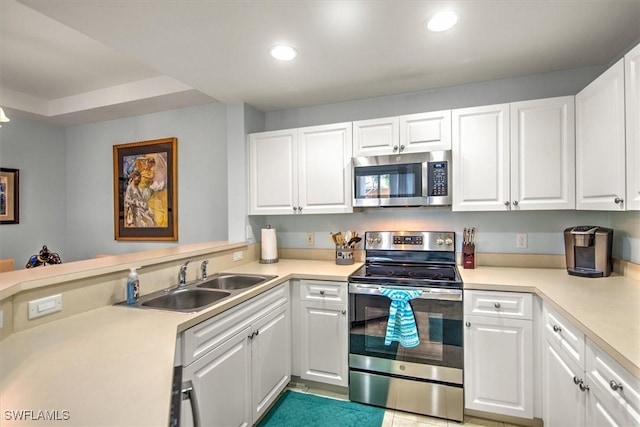 kitchen featuring stainless steel appliances, sink, and white cabinets