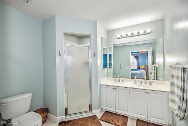 bathroom with toilet, vanity, and walk in shower