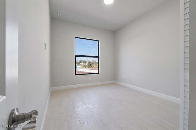 empty room featuring baseboards