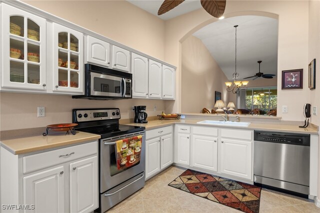 kitchen with stainless steel appliances, decorative light fixtures, sink, and white cabinets