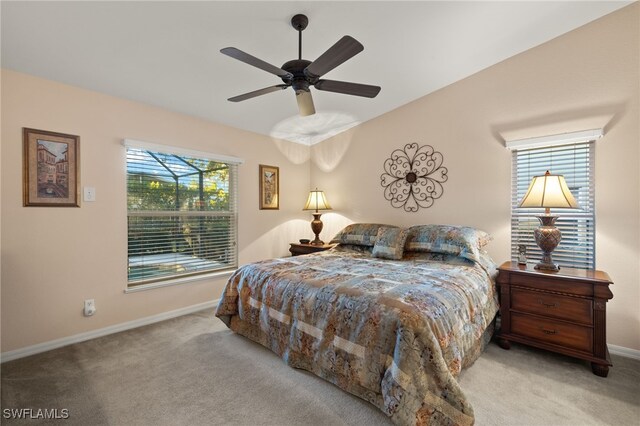 bedroom featuring ceiling fan, light colored carpet, and vaulted ceiling