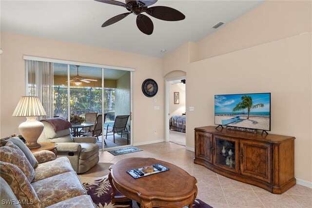 tiled living room with ceiling fan and vaulted ceiling