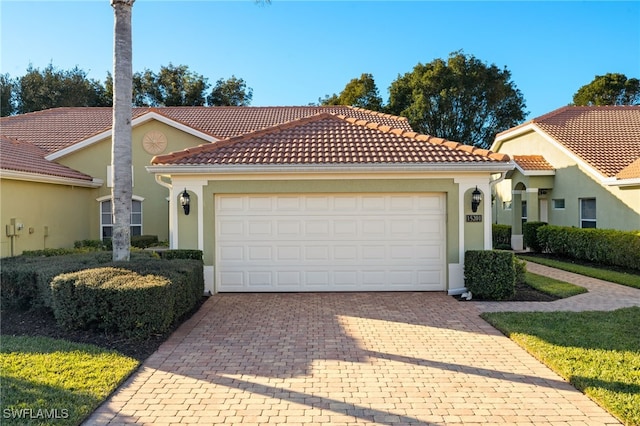 mediterranean / spanish home featuring a garage