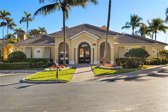 mediterranean / spanish-style home with french doors