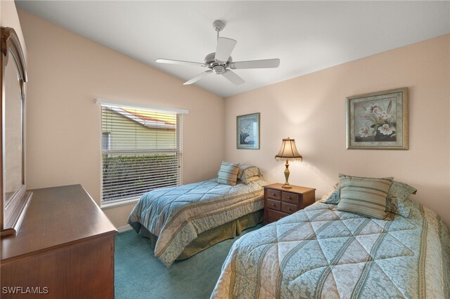 bedroom with ceiling fan, carpet flooring, and vaulted ceiling