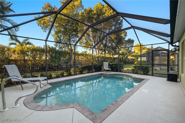 view of pool with a lanai and a patio area